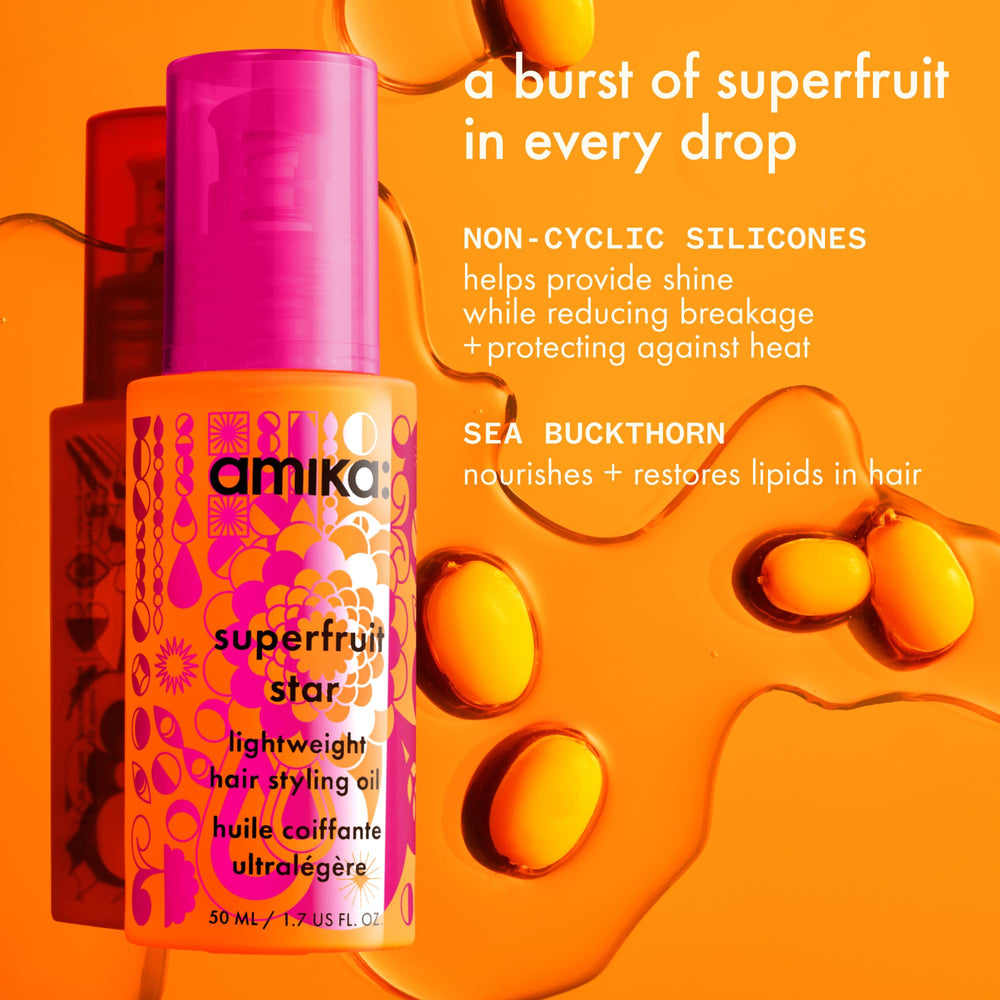 Applying Amika Superfruit Star to damp hair for smoother strands.