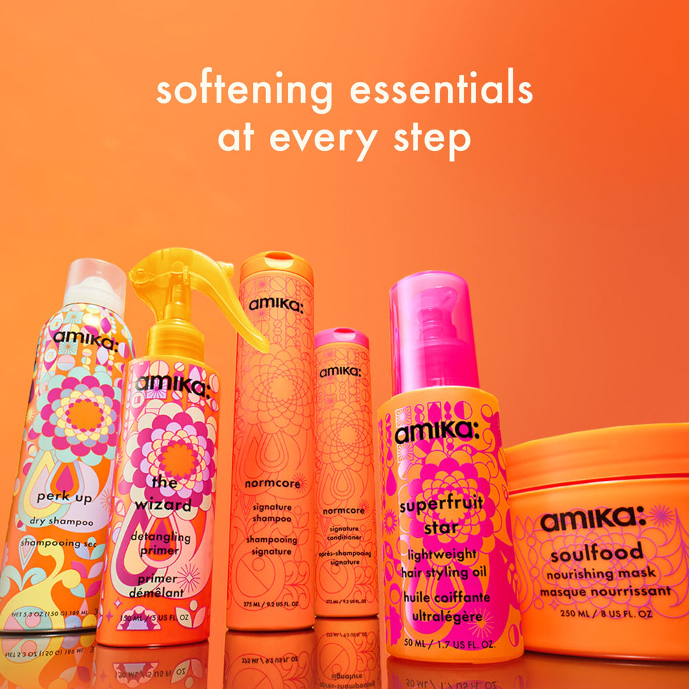 Amika The Wizard Detangling Hair Primer on towel-dried hair ready for styling.