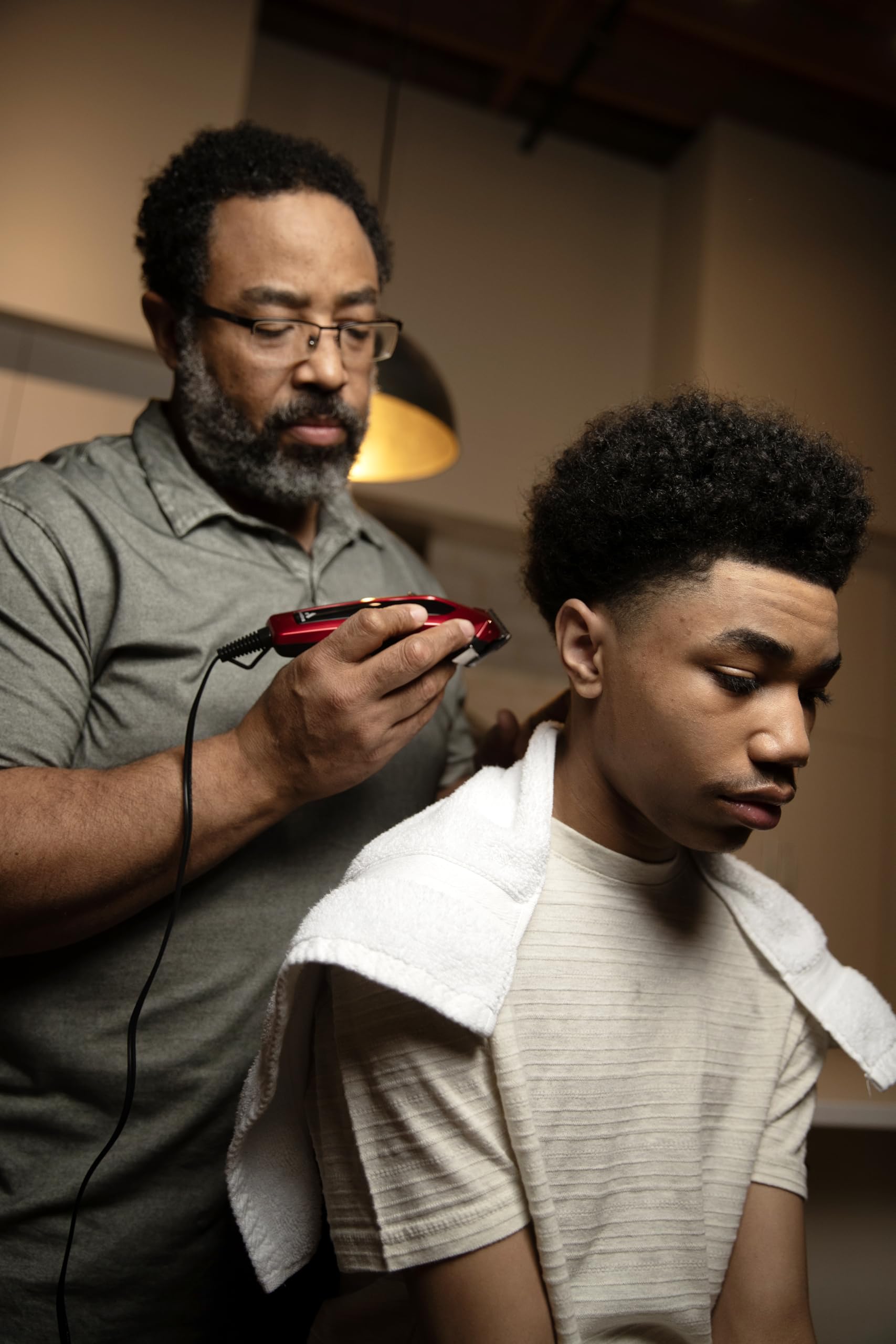 Andis barber comb and shears enable clean detailing and neat trims.