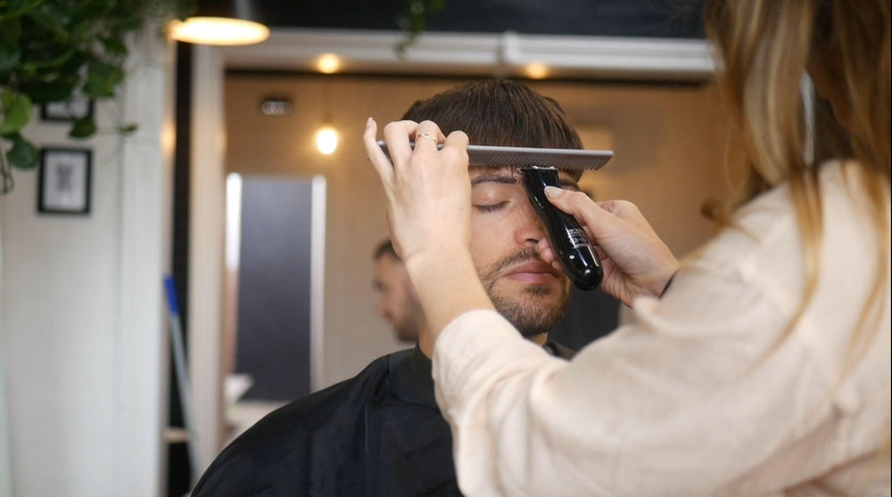 Andis Slimline Pro Li Trimmer with four attachment combs for length options.