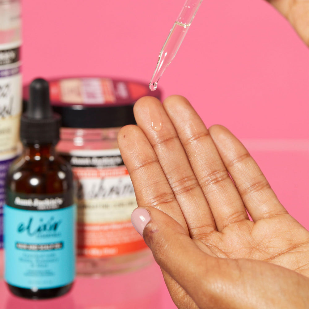 Aunt Jackie's Elixir Essentials application scene demonstrates gentle scalp massage