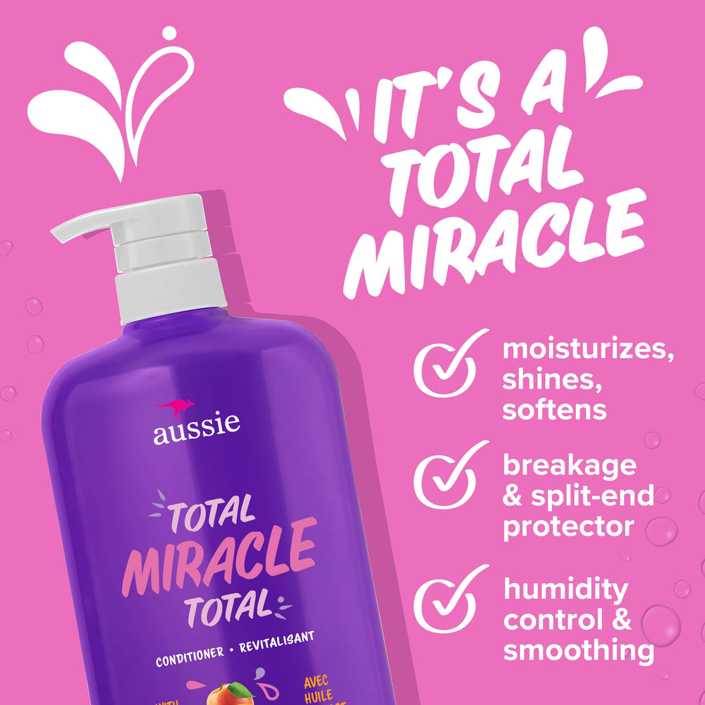 Aussie Total Miracle conditioner being worked through hair to smooth strands.