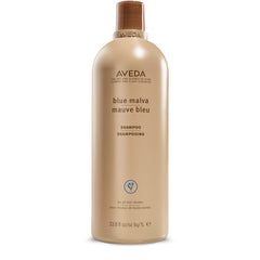 Aveda Blue Malva Shampoo bottle pour cools brassiness in gray and blonde hair.