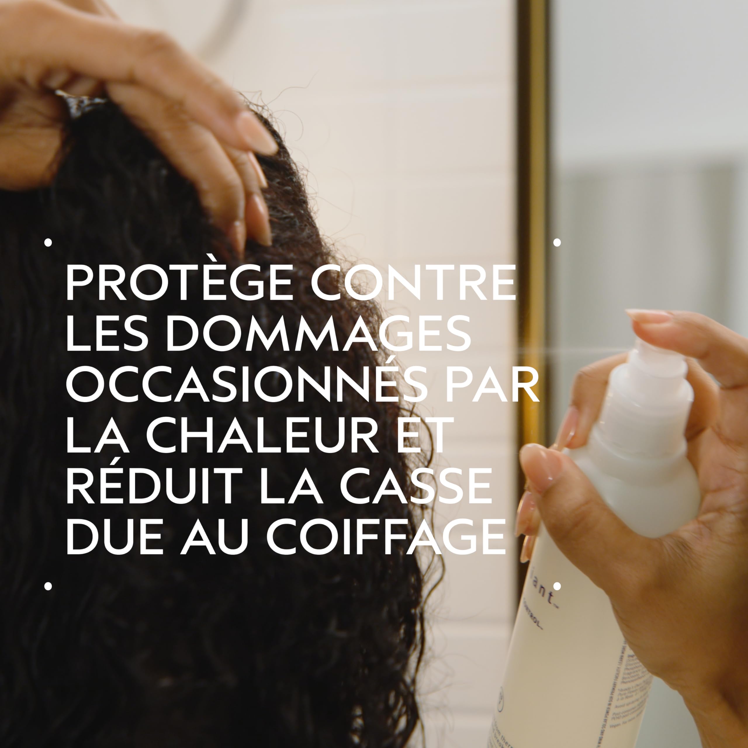 Aveda Brilliant Damage Control spray nozzle releasing protective mist for heat styling.