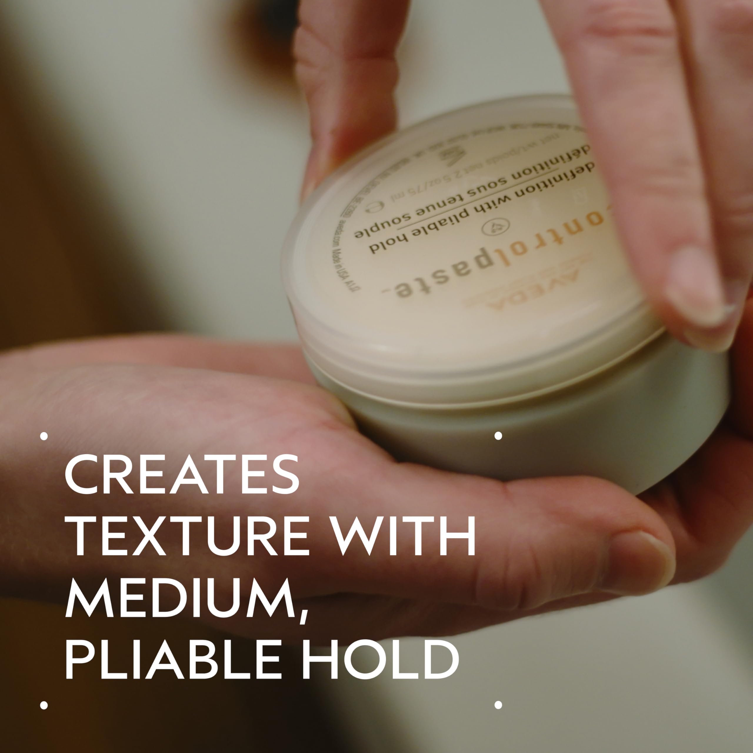 Aveda Control Paste being applied to dry hair for a smooth matte finish