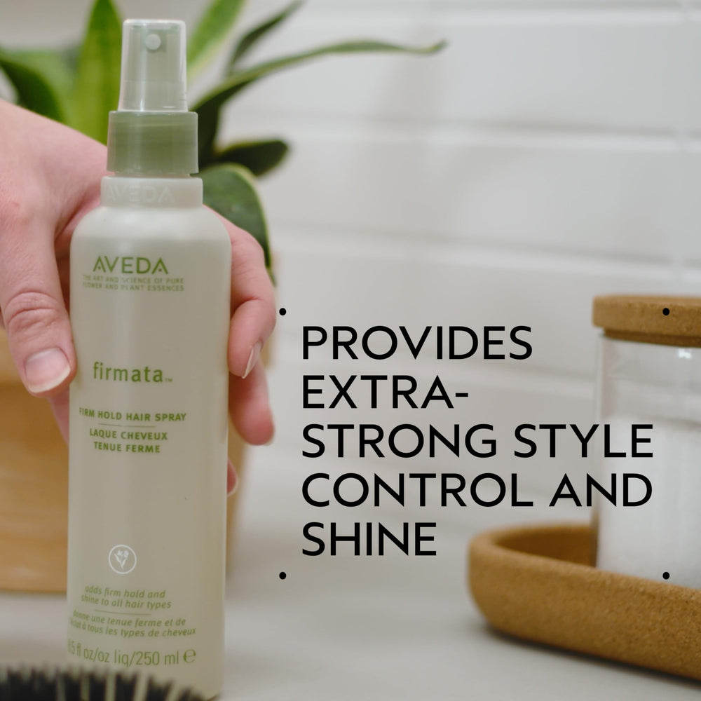 Close-up of Aveda Firmata being misted for strong control.