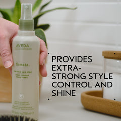 Close-up of Aveda Firmata being misted for strong control.