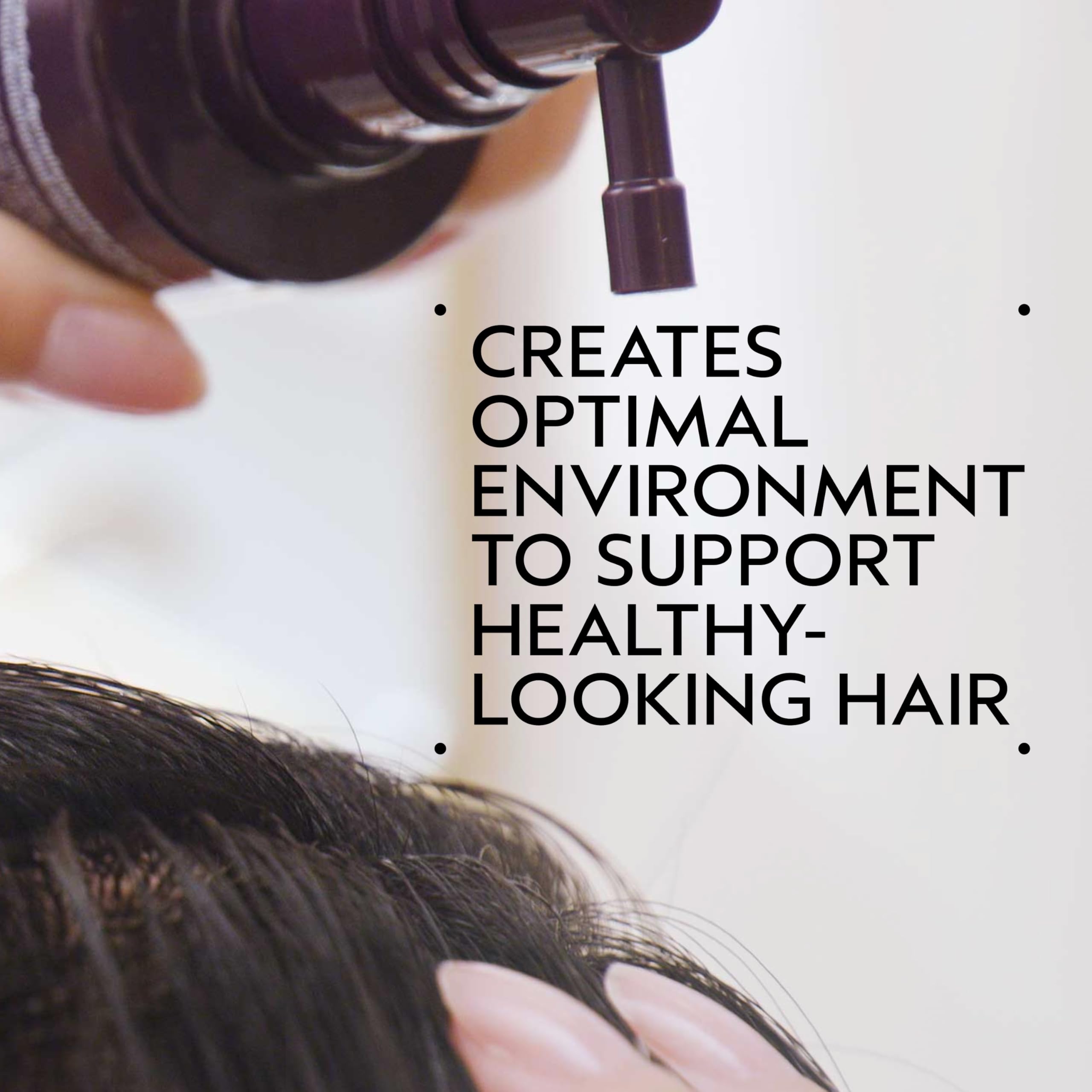 Hands apply Invati Ultra Scalp Serum to the scalp for renewal and energy.