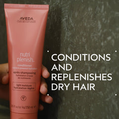 Aveda Nutriplenish Conditioner Light Moisture creamy texture ready for smooth application.