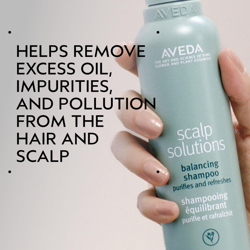 Aveda Scalp Solutions Balancing Shampoo being poured for refreshing cleanse and scalp renewal.