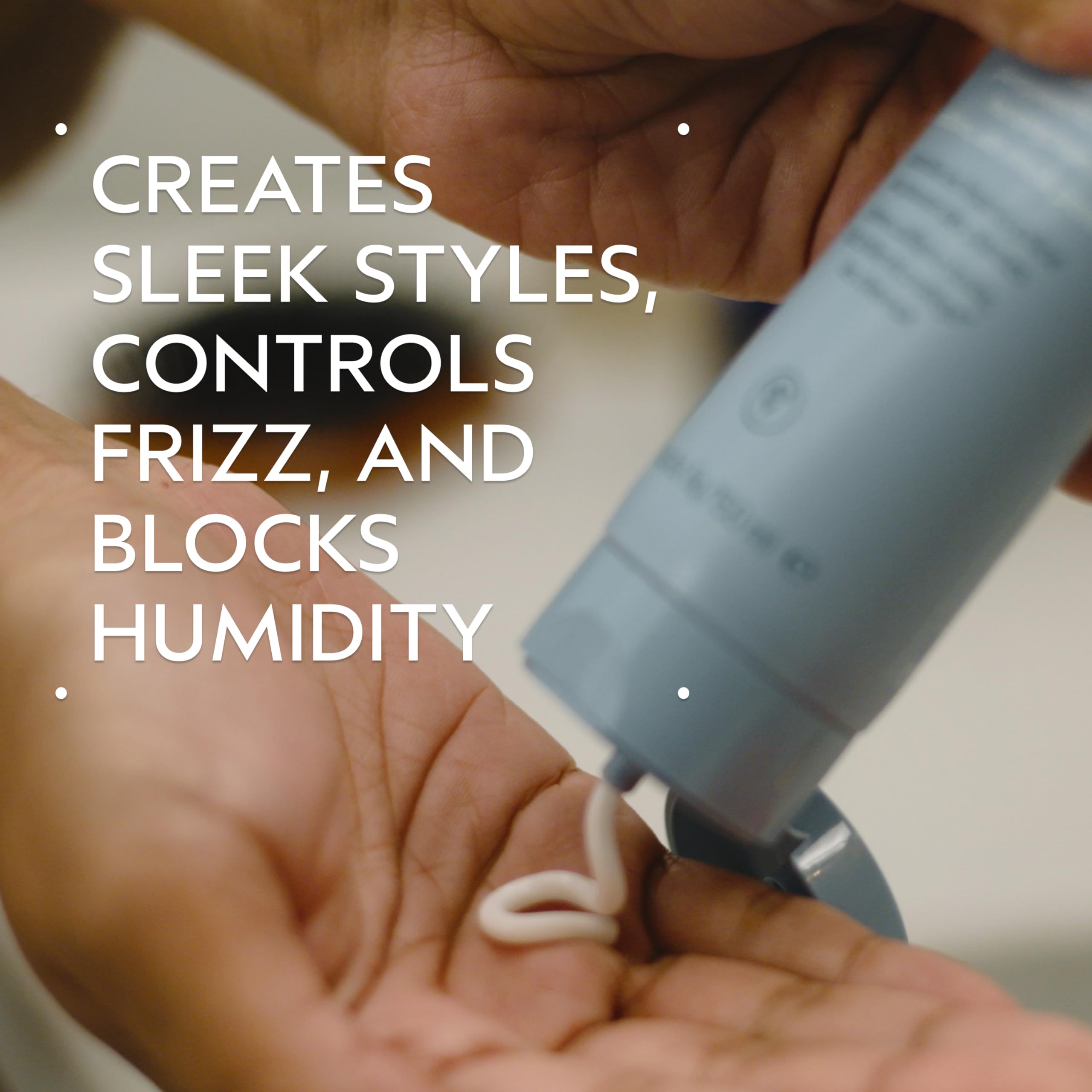 Close-up of Aveda Smooth Infusion Perfectly Sleek applied to curls for smooth blowouts.