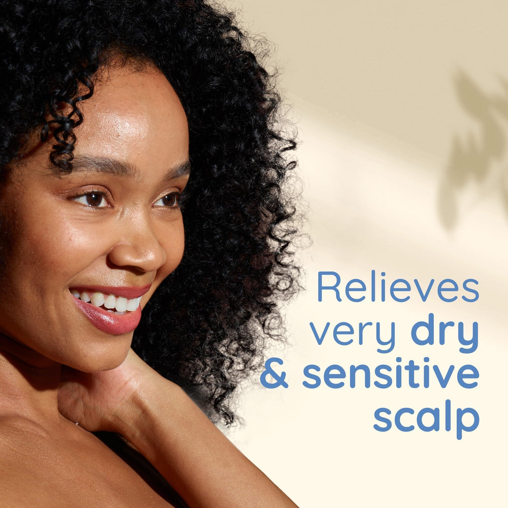 Aveeno Skin Relief Shampoo being poured to show gentle cleansing for fragile hair