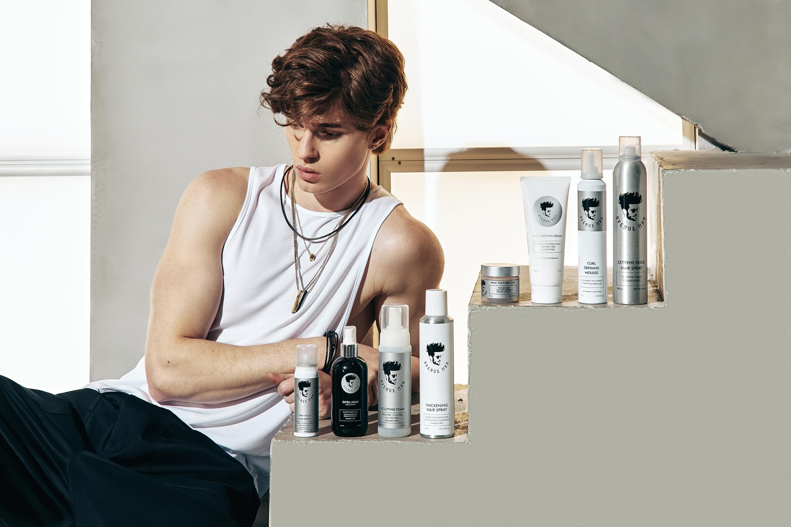 Model with defined curls using Avenue Man Curl Defining Mousse for frizz control.