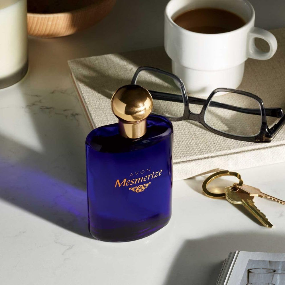 AVON Mesmerize Men amber note closeup under warm lighting.