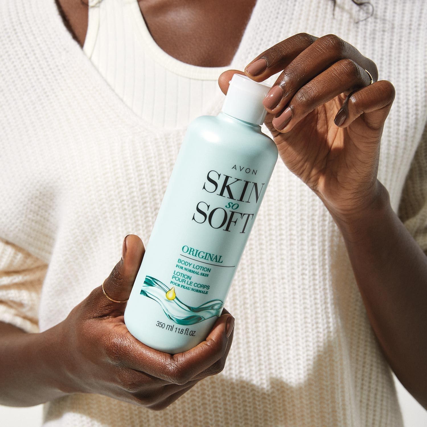 AVON Skin So Soft Original being massaged into skin for comfort.