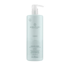 Paul Mitchell Awapuhi Wild Ginger Cream Rinse bottle on shelf, color safe conditioner for damaged hair.