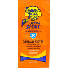 Banana Boat Sport Sunscreen travel packet on beach, fast-absorbing protection.
