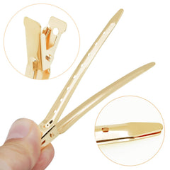 Bantoye gold duck bill clip used to section hair during styling.