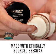 Hands apply Baxter of California Cream Pomade for light hold on hair.