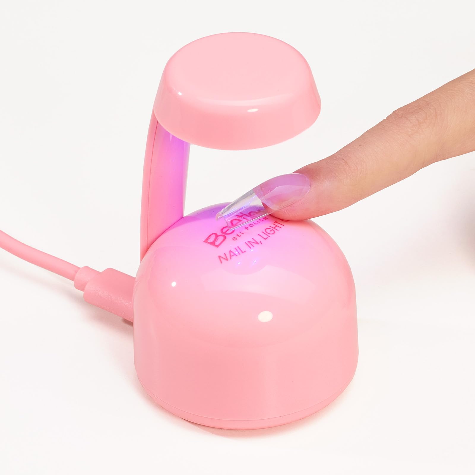 Beetles Mini UV Light glowing pink LED for fast drying of gel polish.
