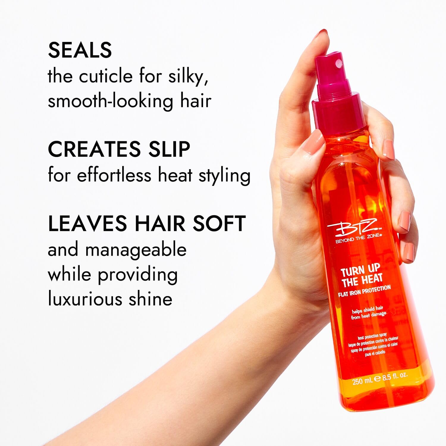 Beyond The Zone Turn Up The Heat Protection Spray in action with a flat iron for heat styling.