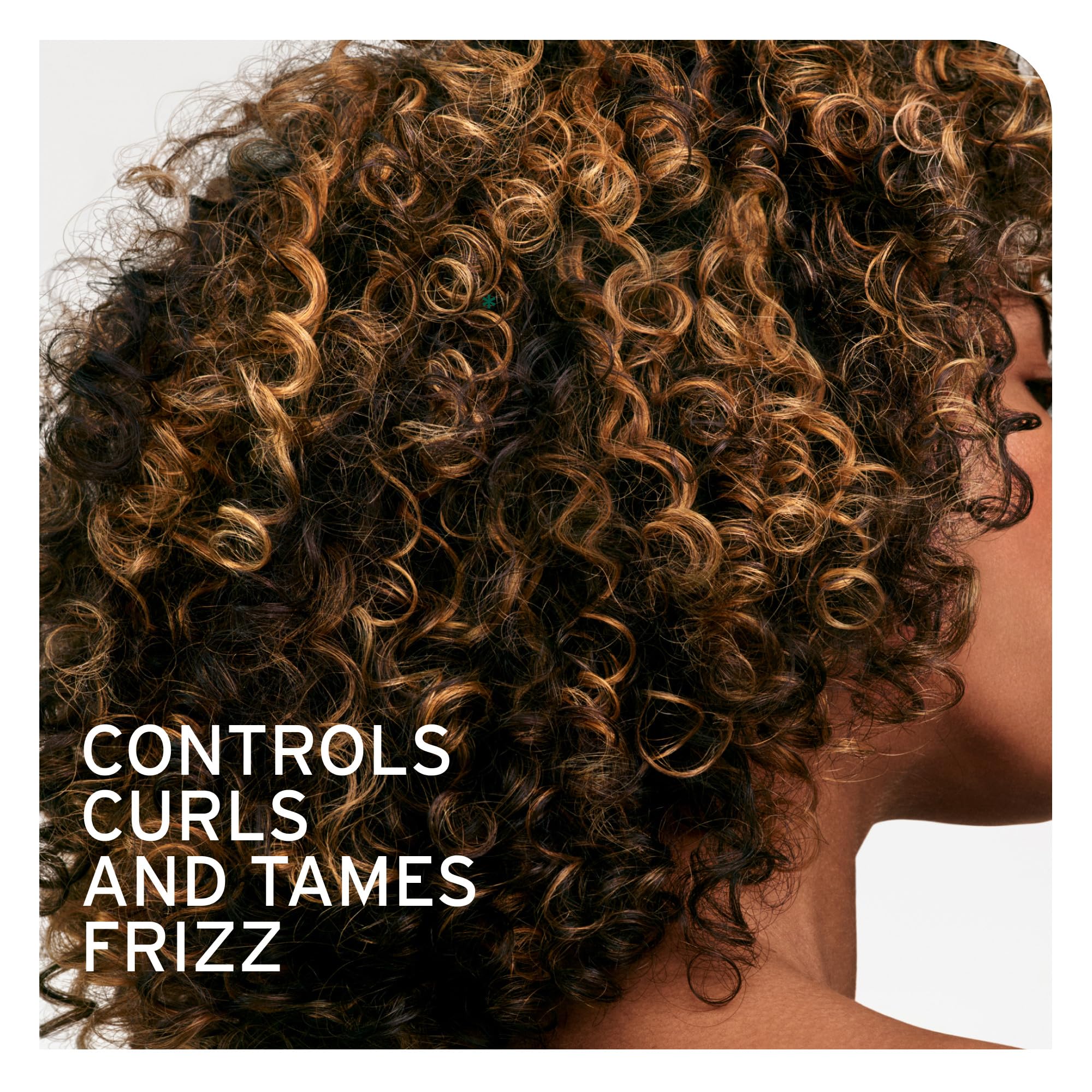 Biolage Curl Defining Elixir texture on damp hair demonstrates defined curls and movement.