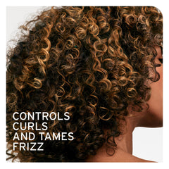 Biolage Curl Defining Elixir texture on damp hair demonstrates defined curls and movement.