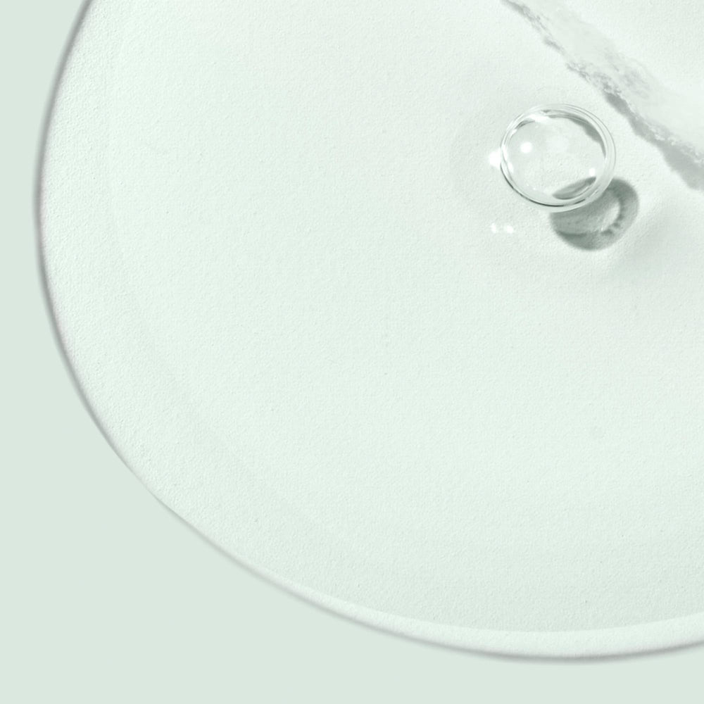 Biossance applying cleansing oil to dry skin during a routine