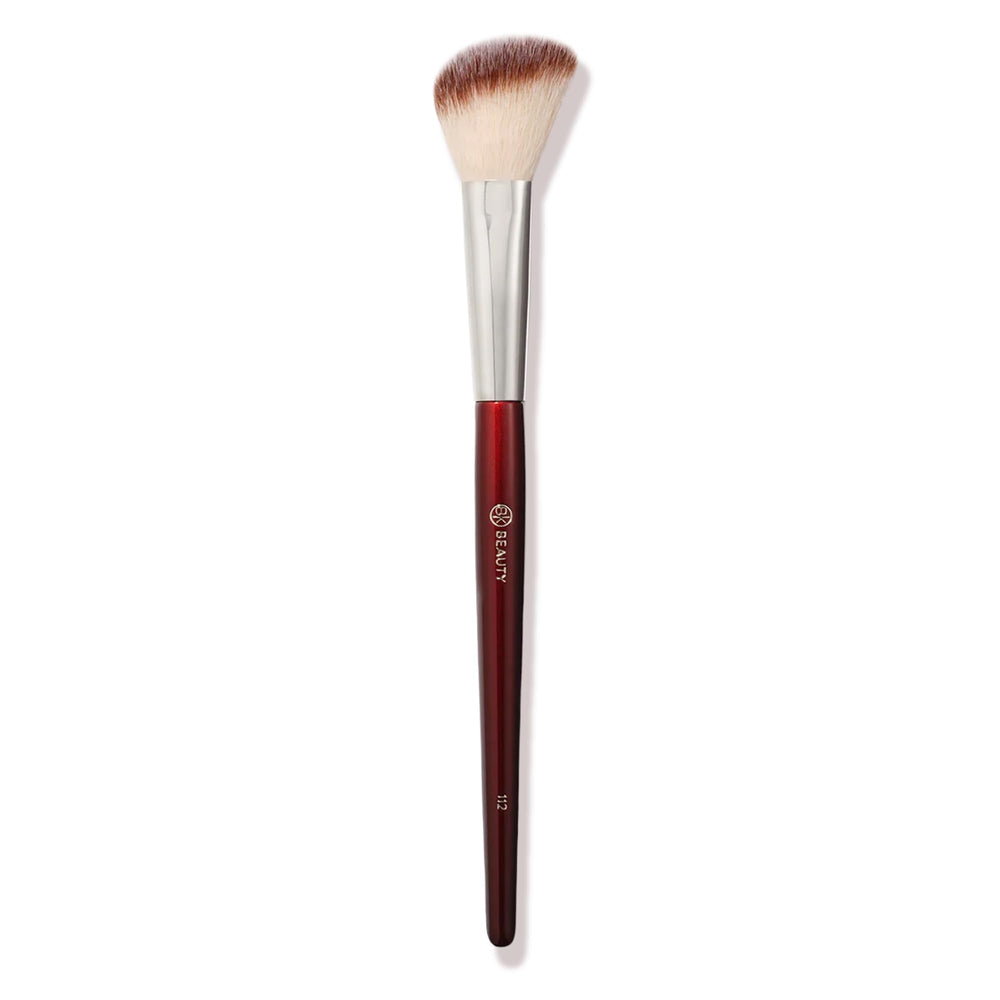 BK BEAUTY 112 small angled face brush held for precise blush placement.