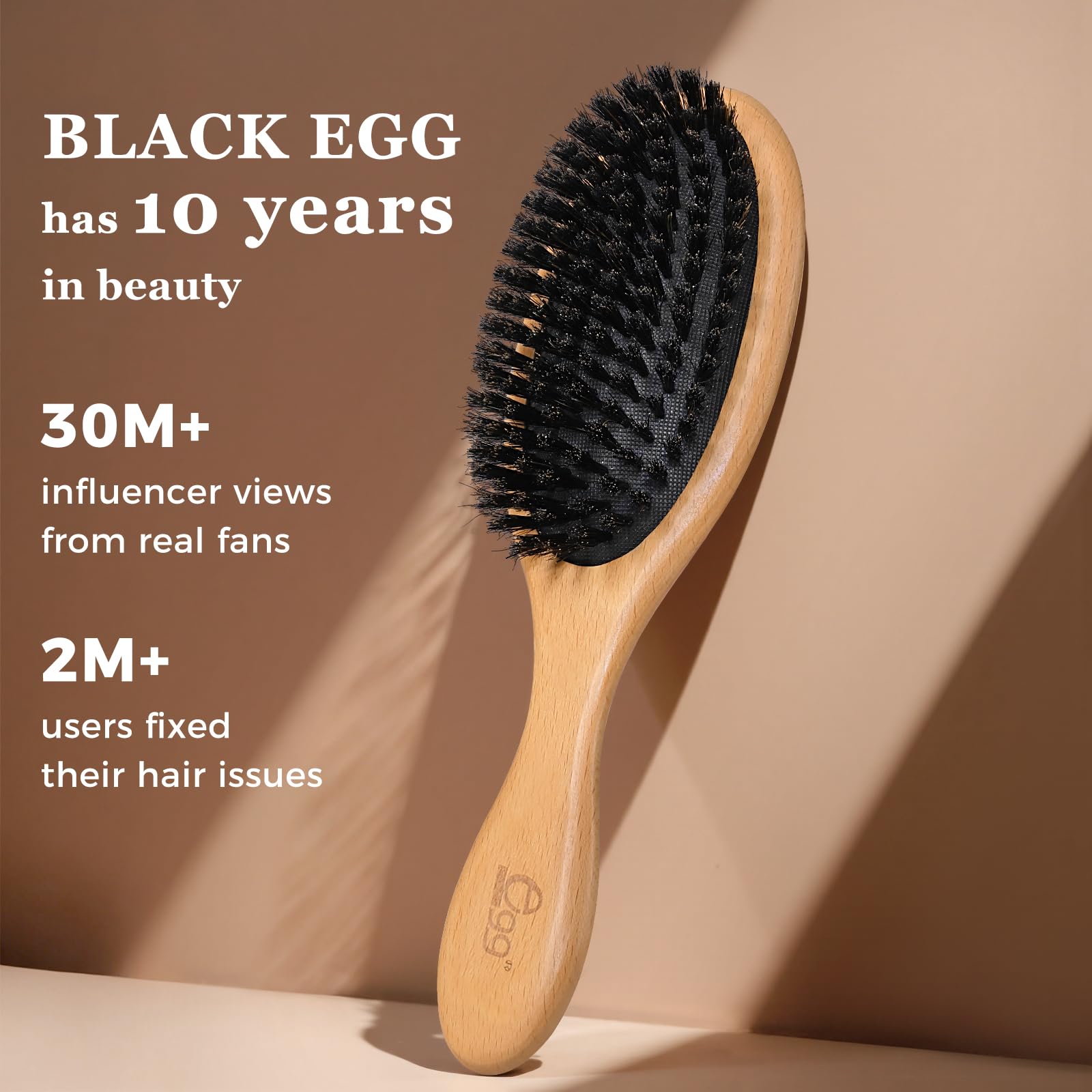 Close-up of BLACK EGG soft boar bristles for gentle massage