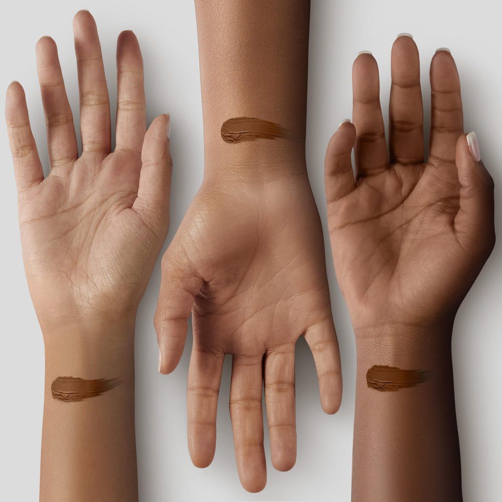 Applying Black Radiance concealer for a natural finish.