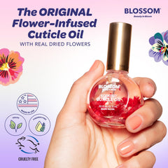 Applying Blossom Cuticle Oil to cuticles for soft, nourished nails