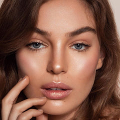 Boobeen highlighter stick on-face detail shows even, radiant finish.