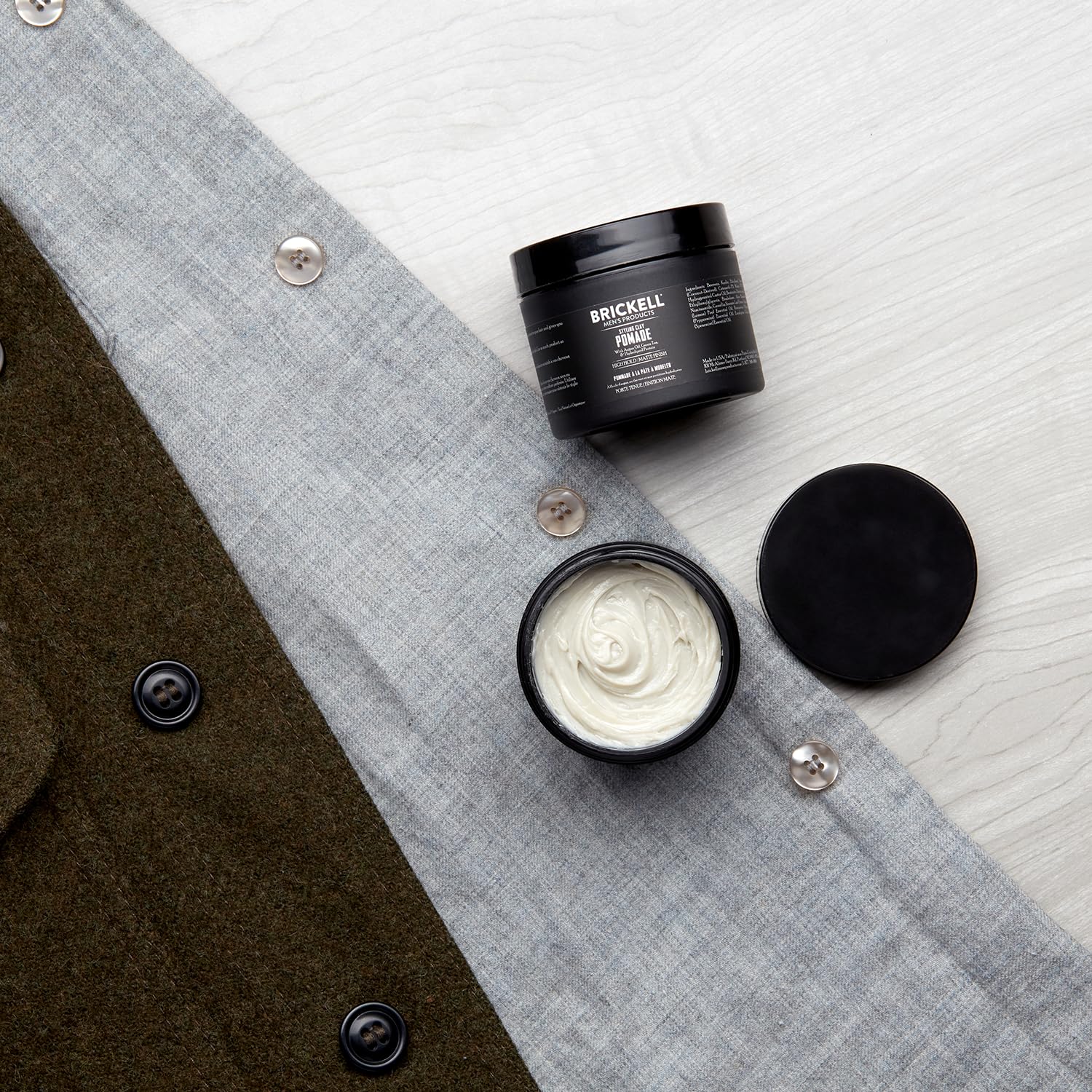 Brickell pomade in hand for pliable matte styling