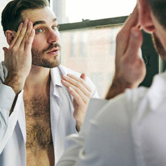 Brickell Men's serum application on skin showing quick absorption.