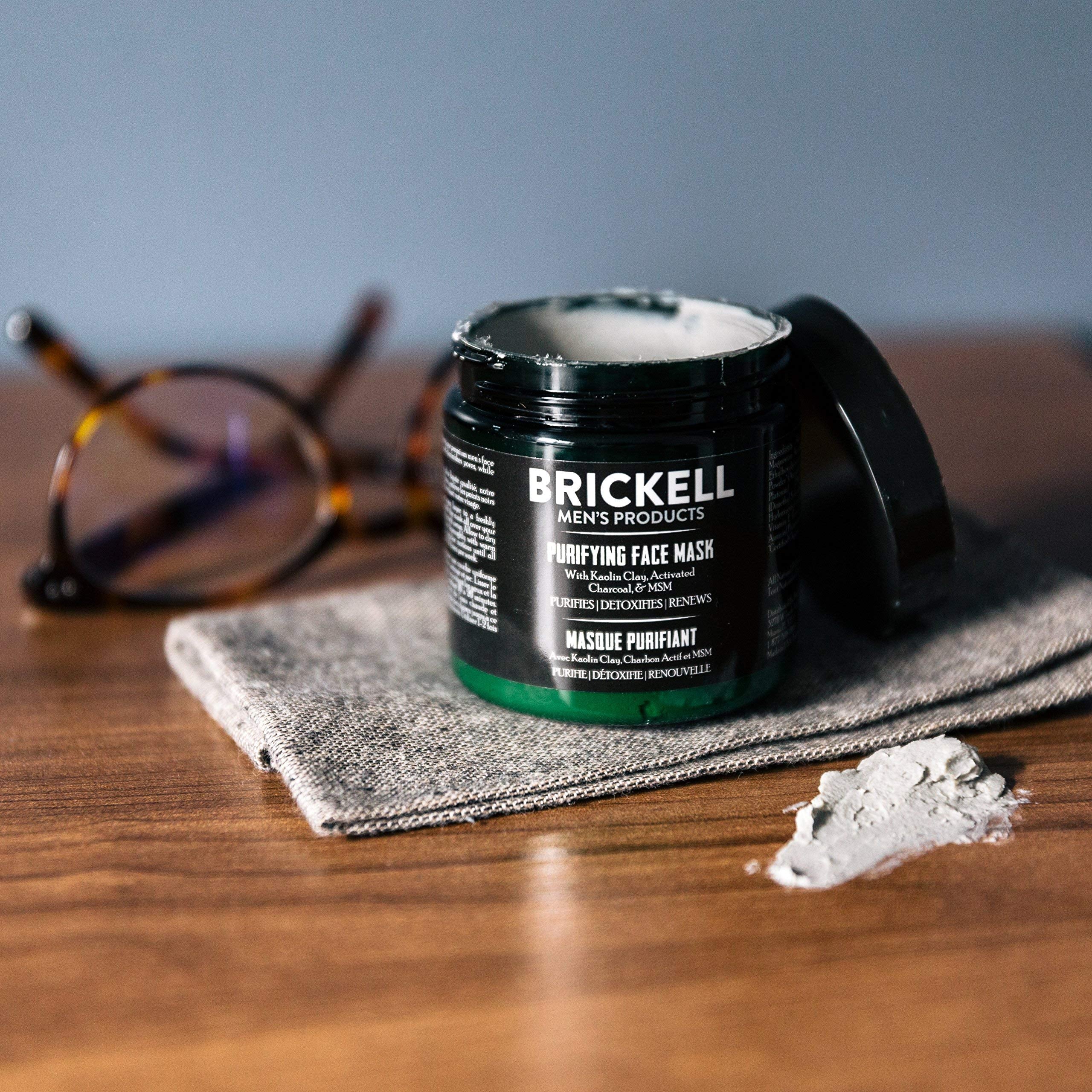 Brickell Men's Purifying Charcoal Face Mask kaolin clay application on skin.