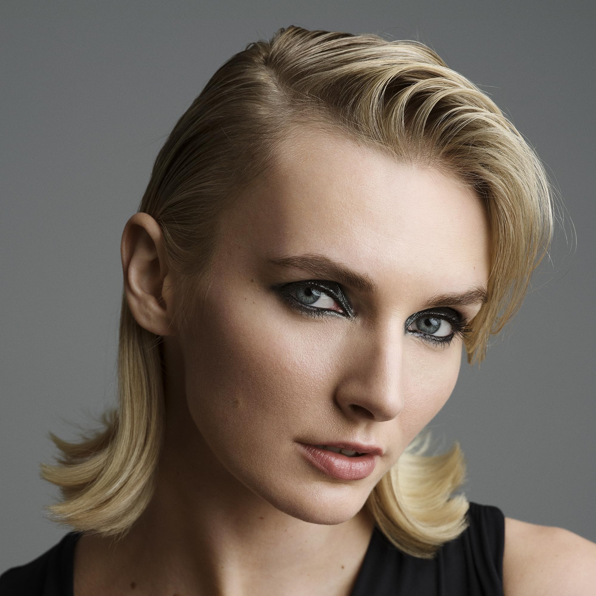 Hands applying Brilliantine for a casual, tousled look