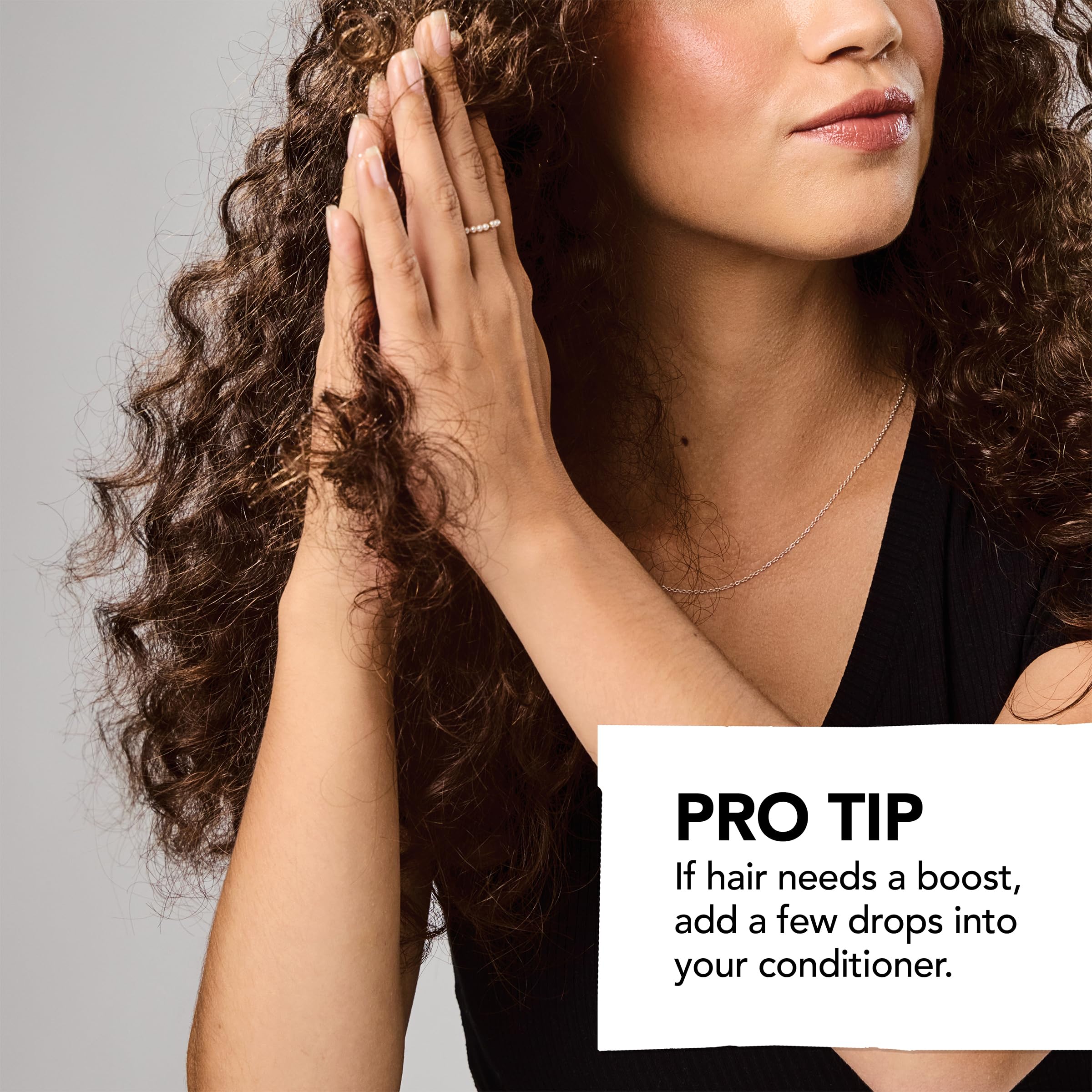 Bumble and bumble frizz-reducing oil close-up reveals silky glossy finish