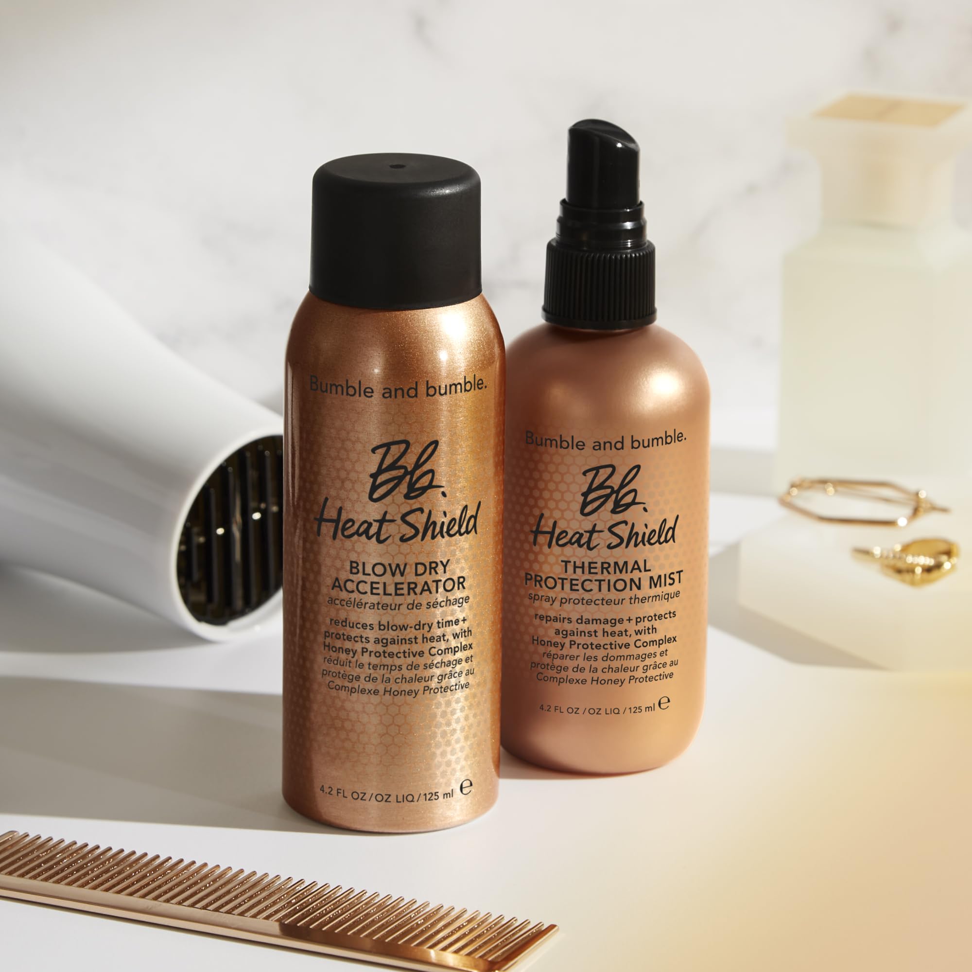 Bumble and bumble Heat Shield product on bathroom counter beside styling tools for easy routine.