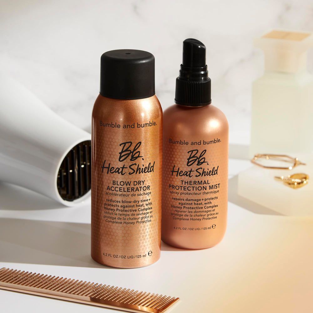 Bumble and bumble Heat Shield product on bathroom counter beside styling tools for easy routine.