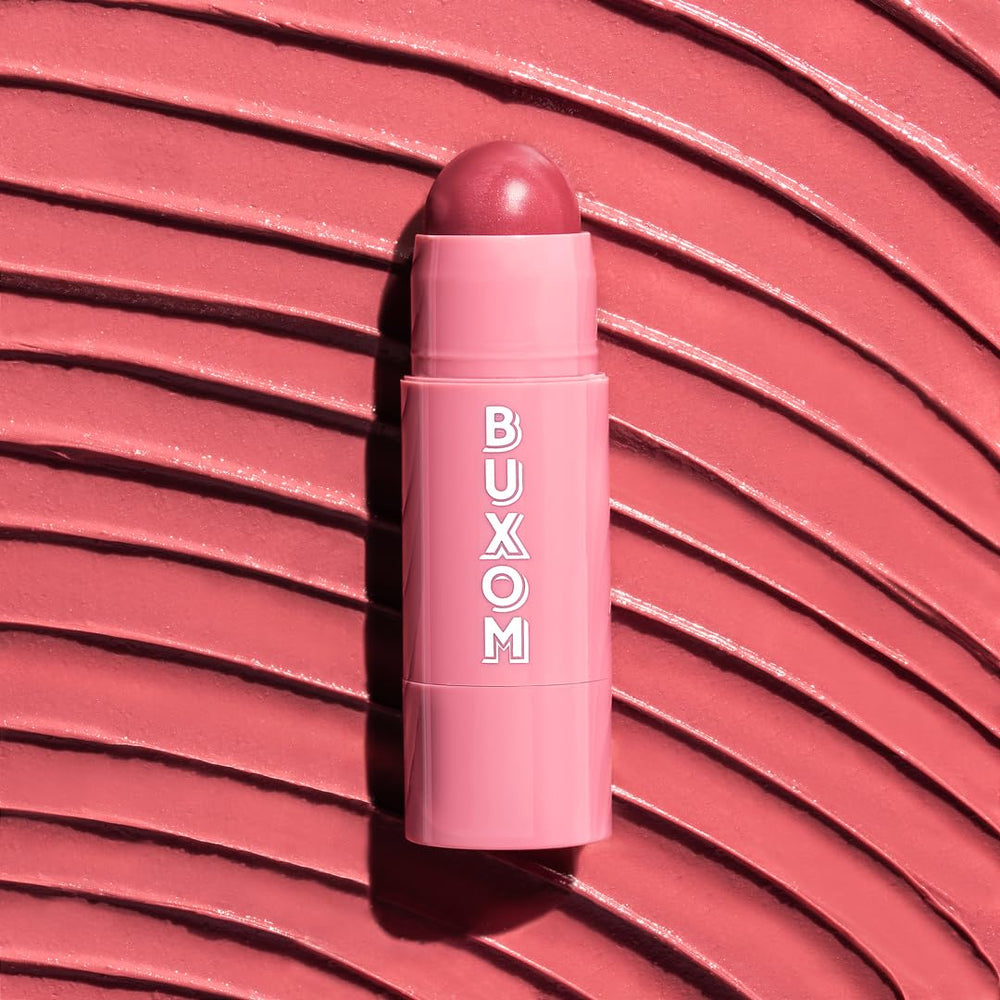BUXOM Dolly Fever tube on shelf suggests easy layering with other lip products.
