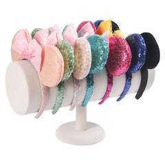 Beige velvet headband display stand from ByKen adds warm elegance to vanity storage.