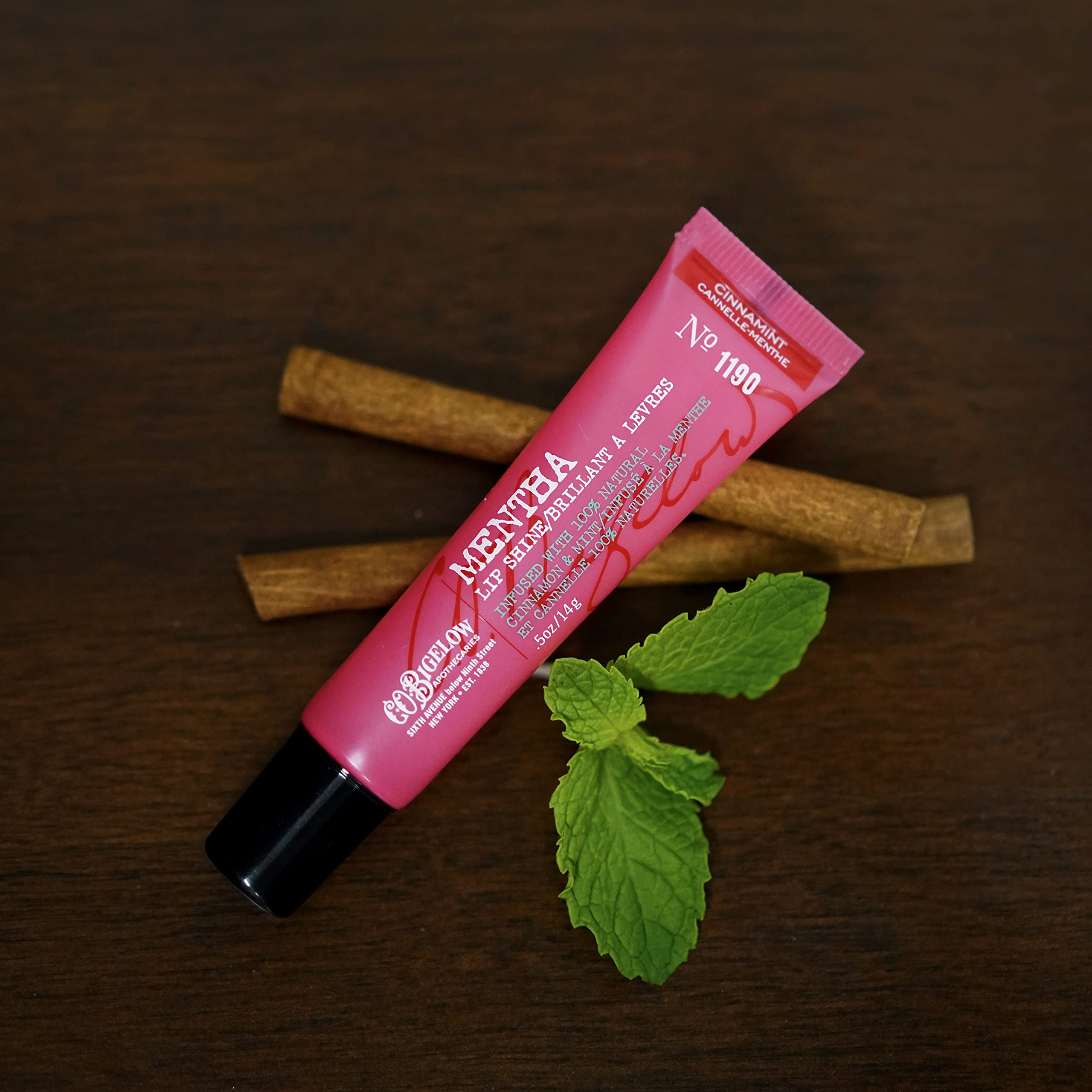Angled C.O. Bigelow cinnamint lip shine tube demonstrates easy application