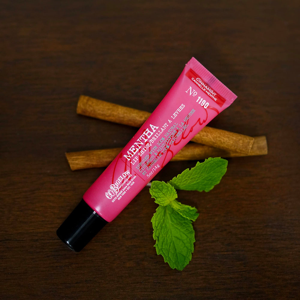 Angled C.O. Bigelow cinnamint lip shine tube demonstrates easy application