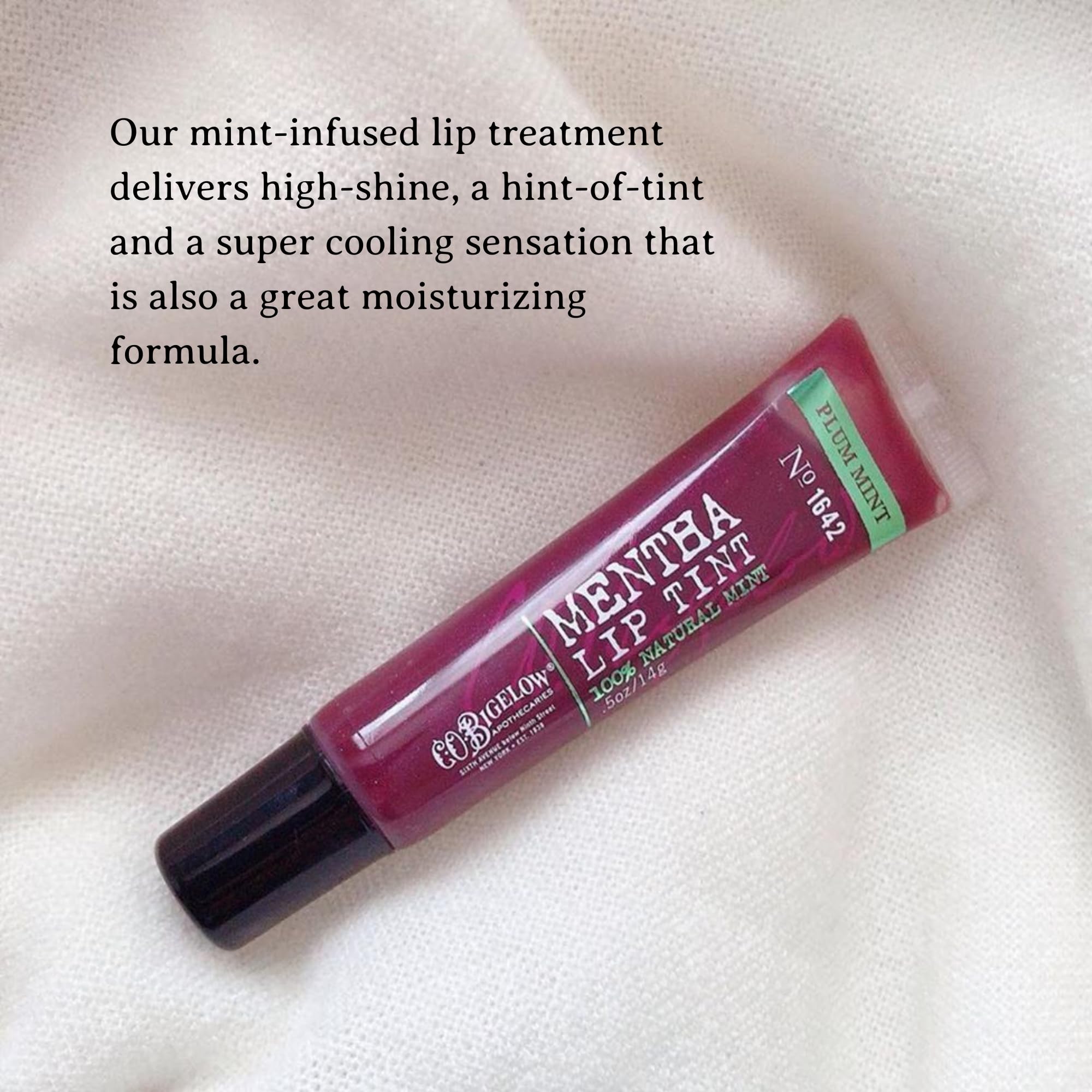 C.O. Bigelow Plum Mentha Lip Tint on lips offers sheer color and cooling sensation.