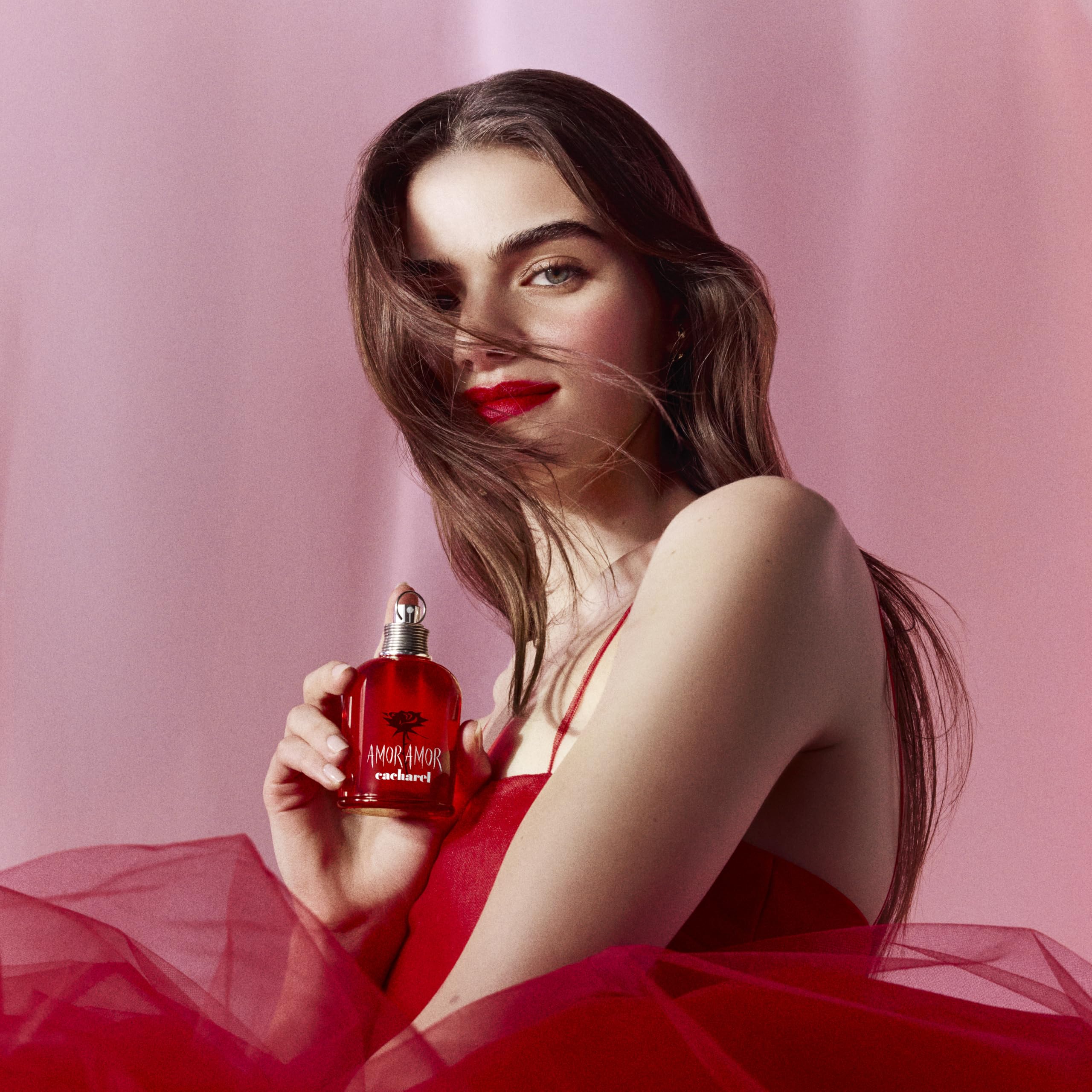 Cacharel Amor Amor bottle with engraved grenade cap highlighting bold, romantic scent cues.