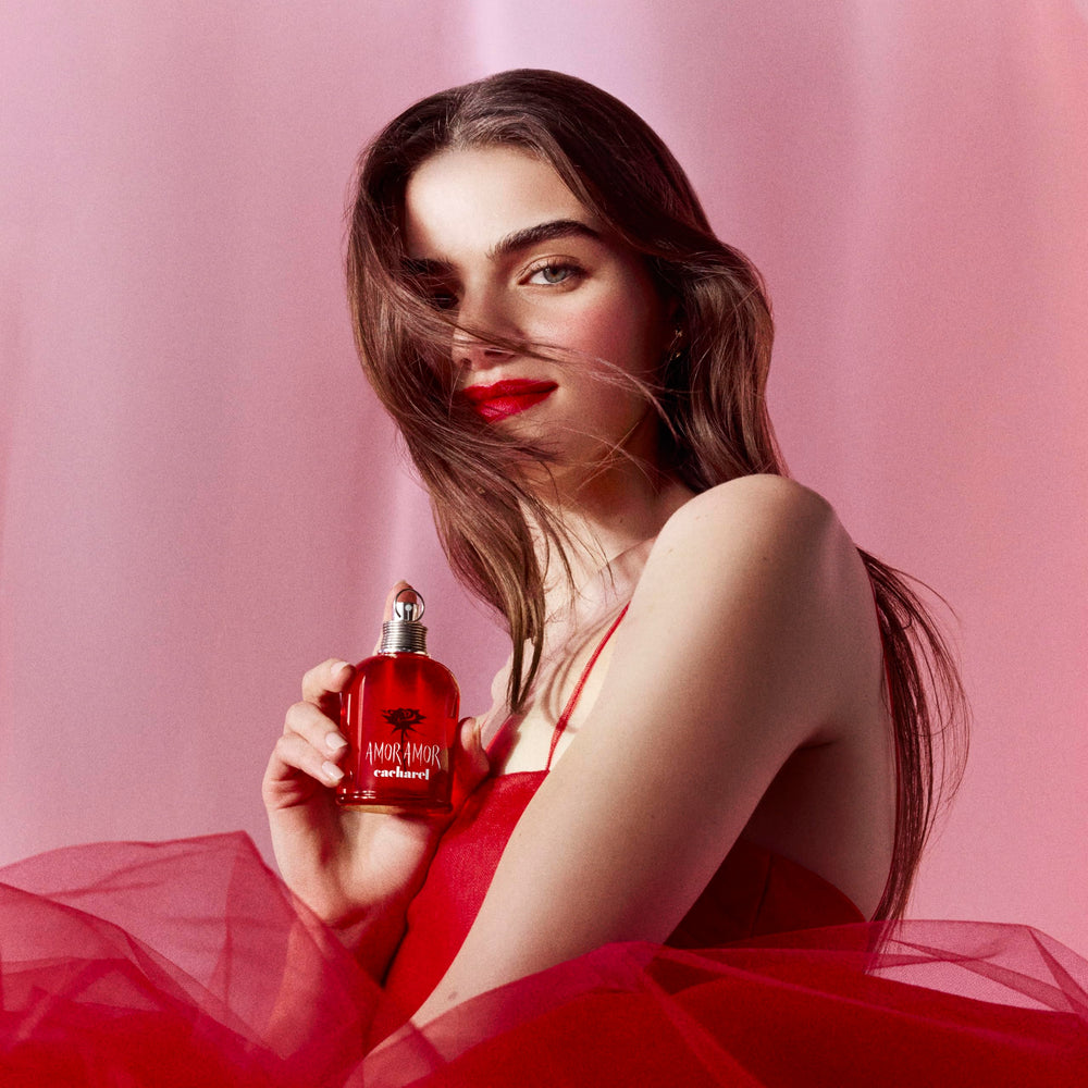 Cacharel Amor Amor bottle with engraved grenade cap highlighting bold, romantic scent cues.