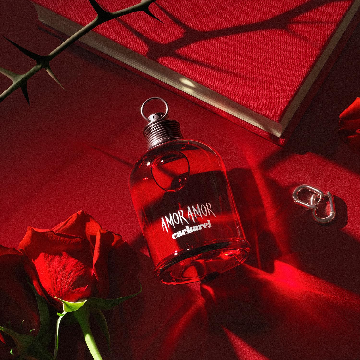 Cacharel Amor Amor spray bottle in action demonstrates easy application.