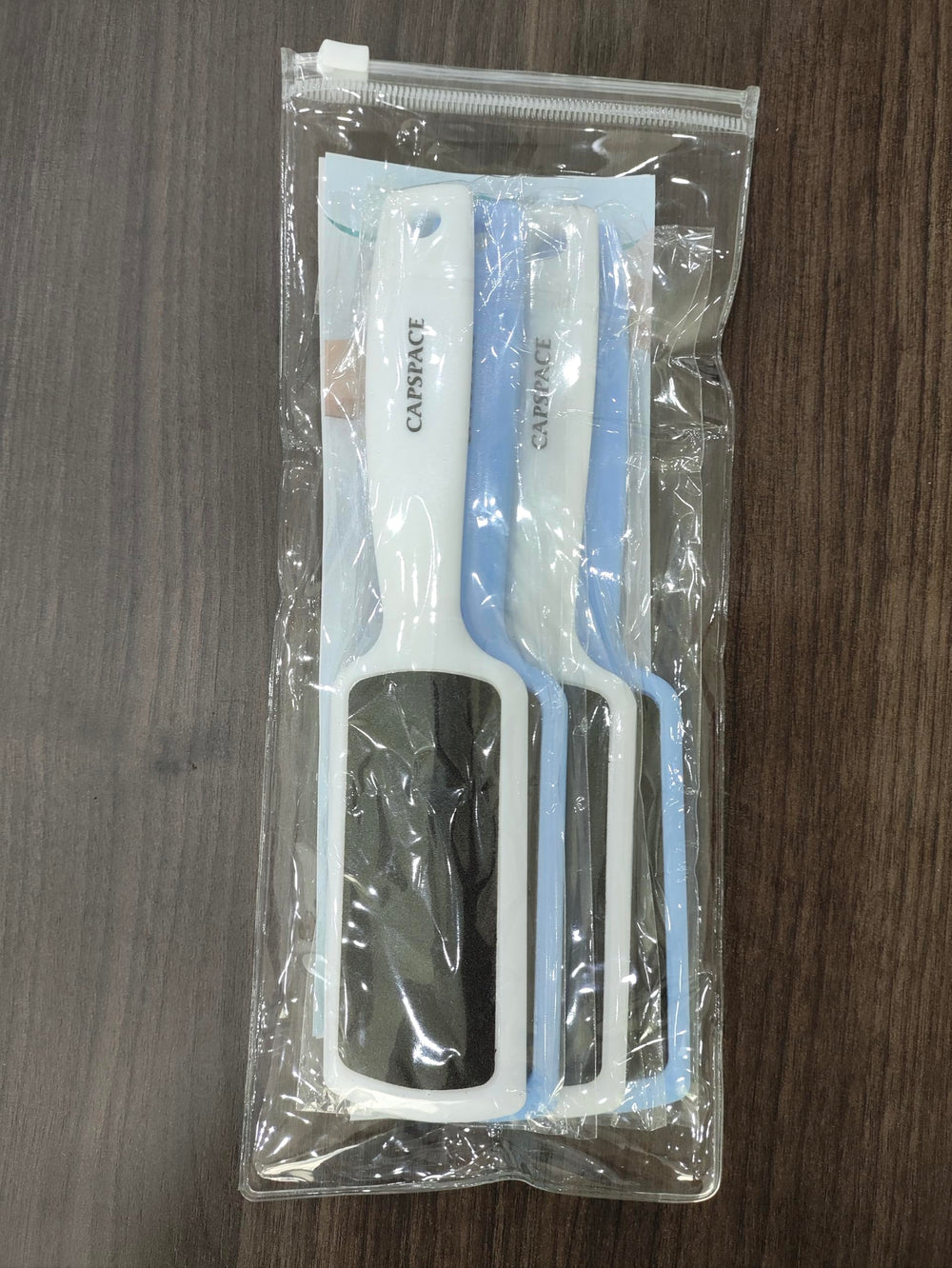 Capspace dual-sided foot rasp exfoliates and smooths calluses safely.
