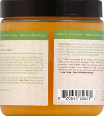 Aplicación en manos de Carol's Daughter Mimosa Hair Honey Shine Pomade para nutrición del cuero cabelludo